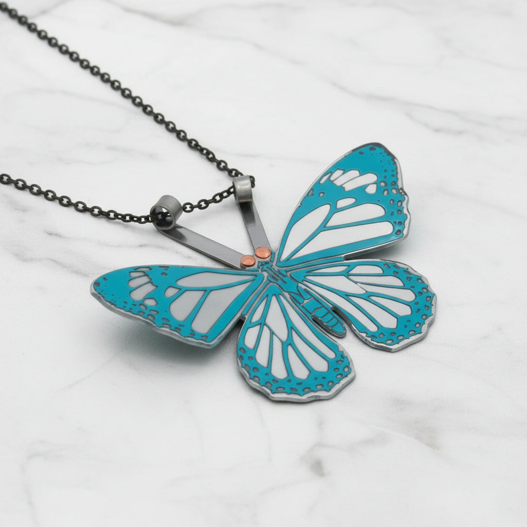 Butterfly-shaped pendant with turquoise wings on a white background