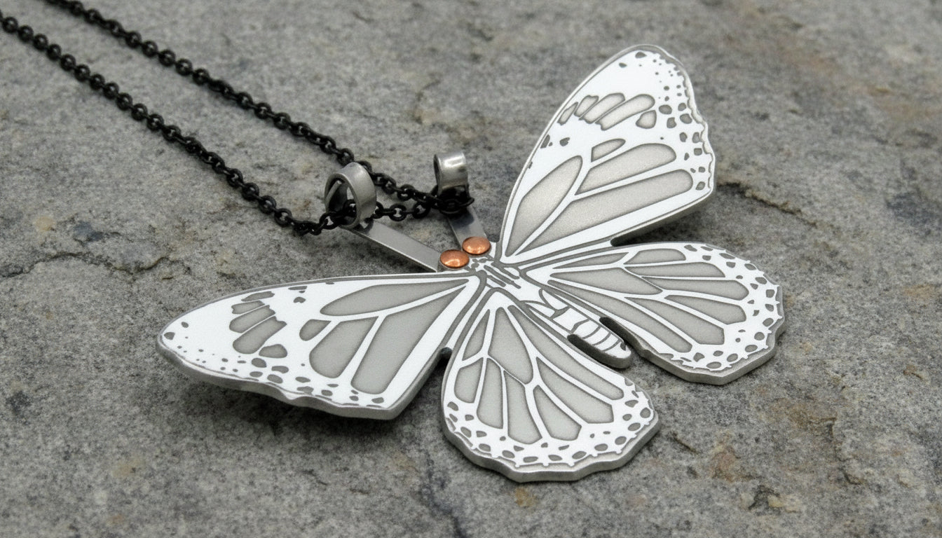 Butterfly-shaped pendant on a chain against a white background
